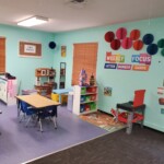 Debary Sonshine Academy classroom with desks for studying and storage organization area near a wall.