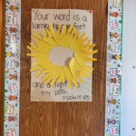 A self-made sun made out of cutouts from yellow paper in shape of palms.