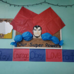 Superman made out of paper with sign underneath stating 'Our Super Powers: Pray, Courage, Obey, Love, Faith'.